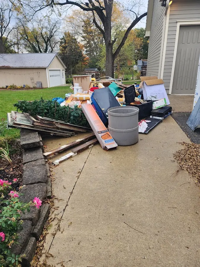 Dumpster being loaded with debris for Estate Cleanout Dumpster Rental in Waterboro